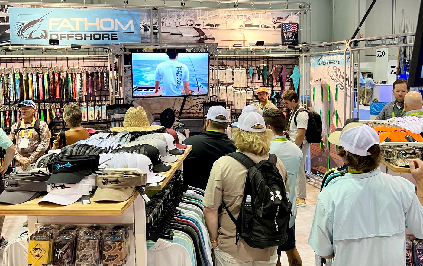 a number of people shopping for offshore fishing tackle at a Fathom Offshore tackle shop