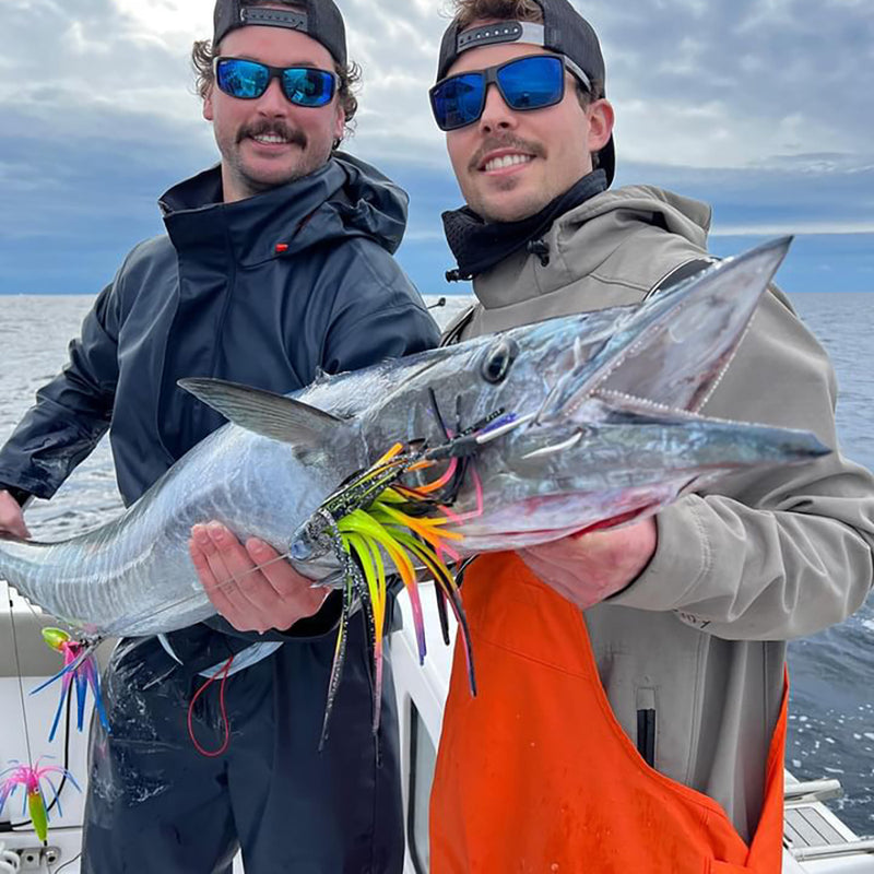Offshore anglers holding Wahoo with Fathom Offshore high speed trolling lure
