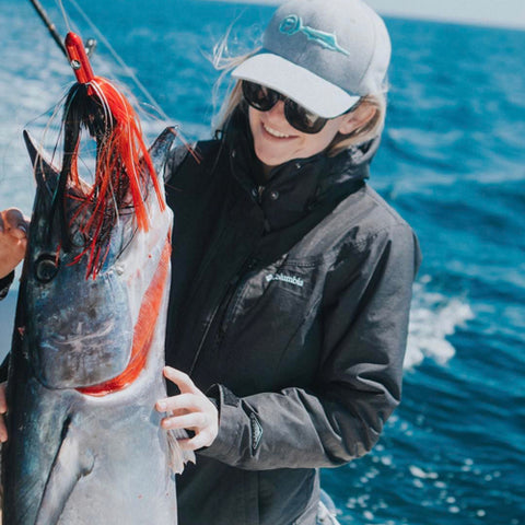 Girl with a Wahoo caught on a Red | Black trolling lure 