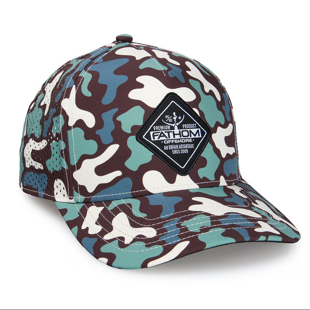 A structured baseball cap featuring a multi-color camouflage pattern in brown, teal, and off-white. It has a black diamond-shaped patch on the front with the brand name 'FATHOM OFFSHORE' and a fisherman graphic.